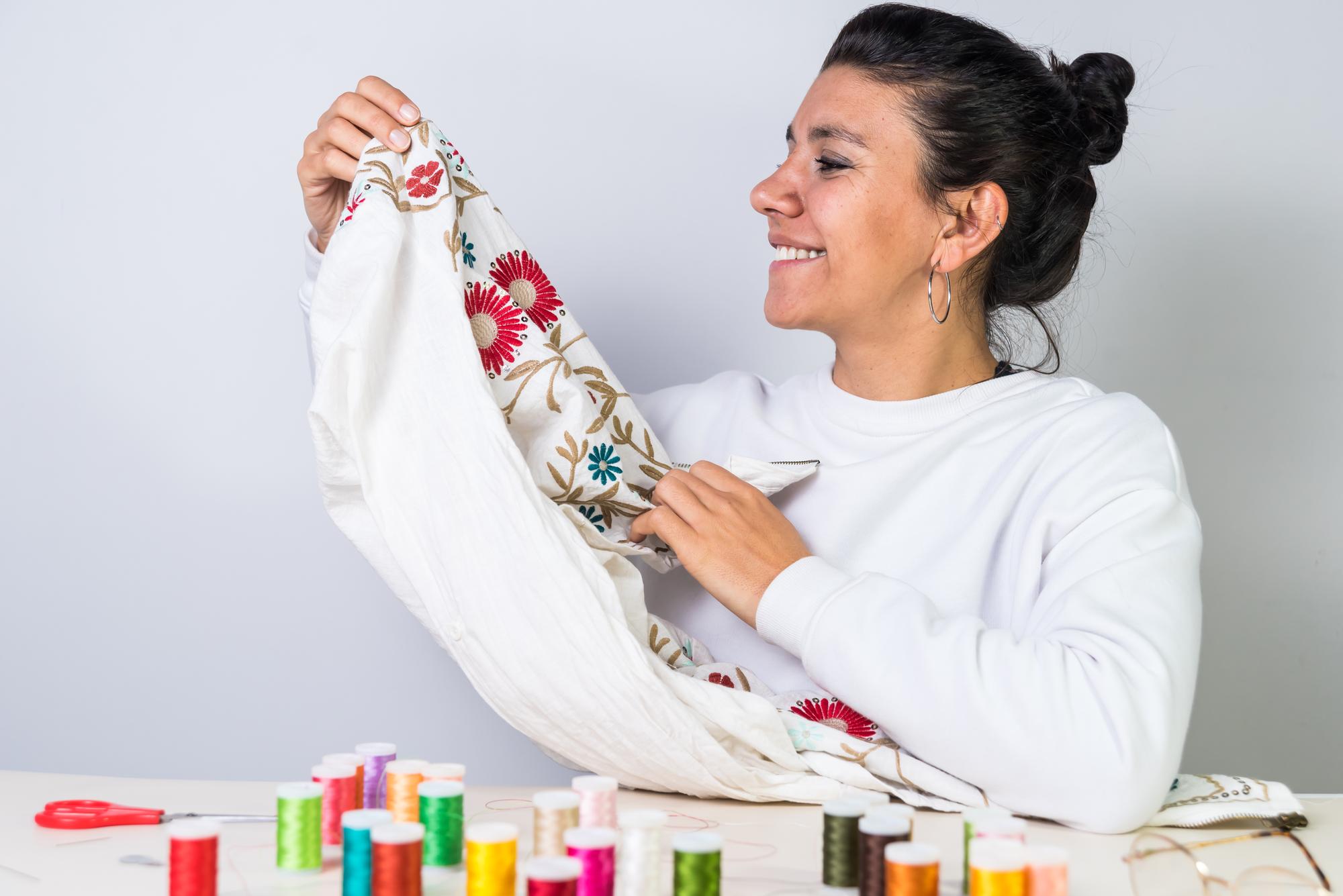 Artisan embroiderer stitching a floral motif on fabric